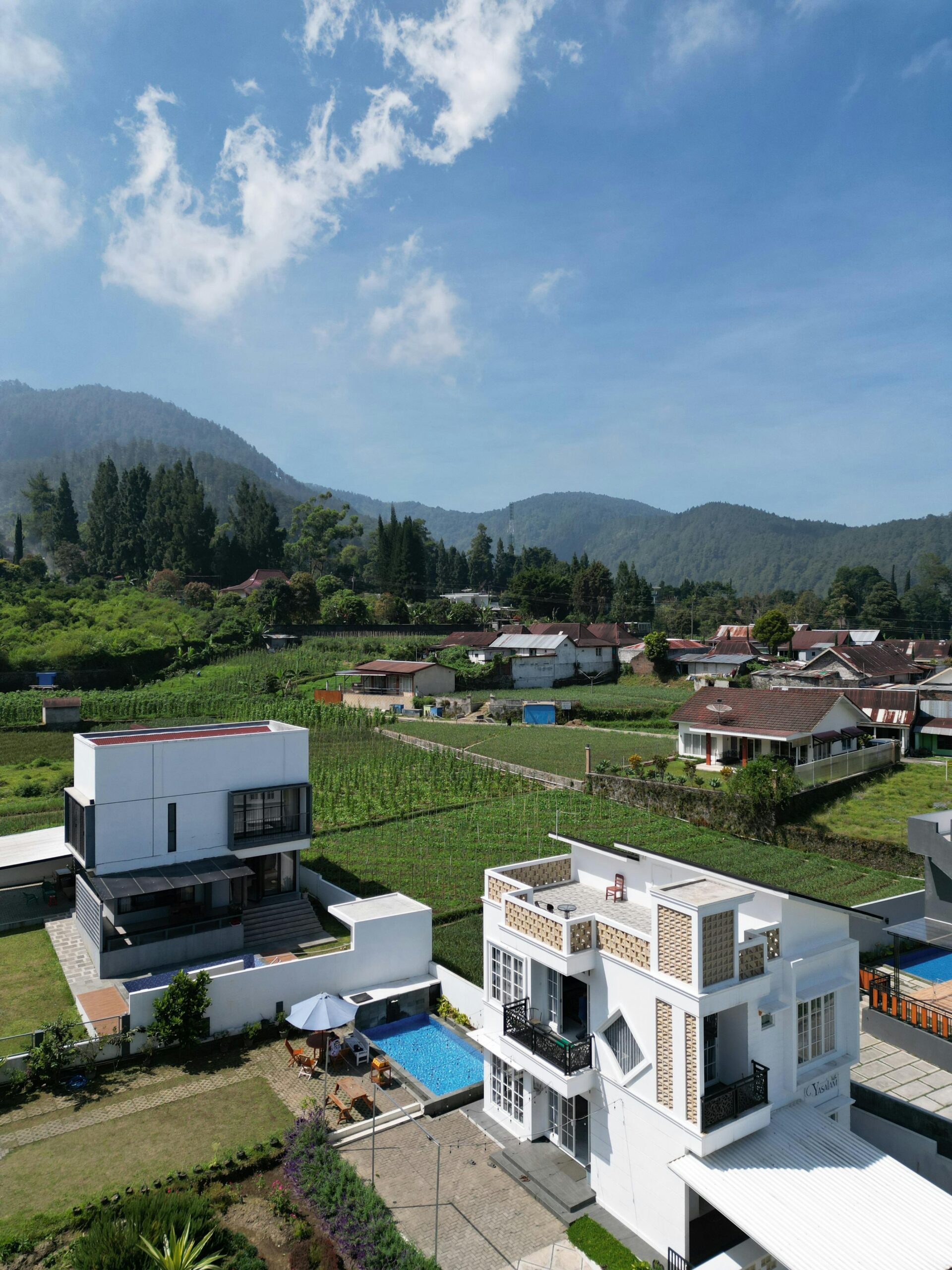 building & civil engineering in Ghana. Jem Prime Limited. Modern villa with pool surrounded by lush green valley and mountains.